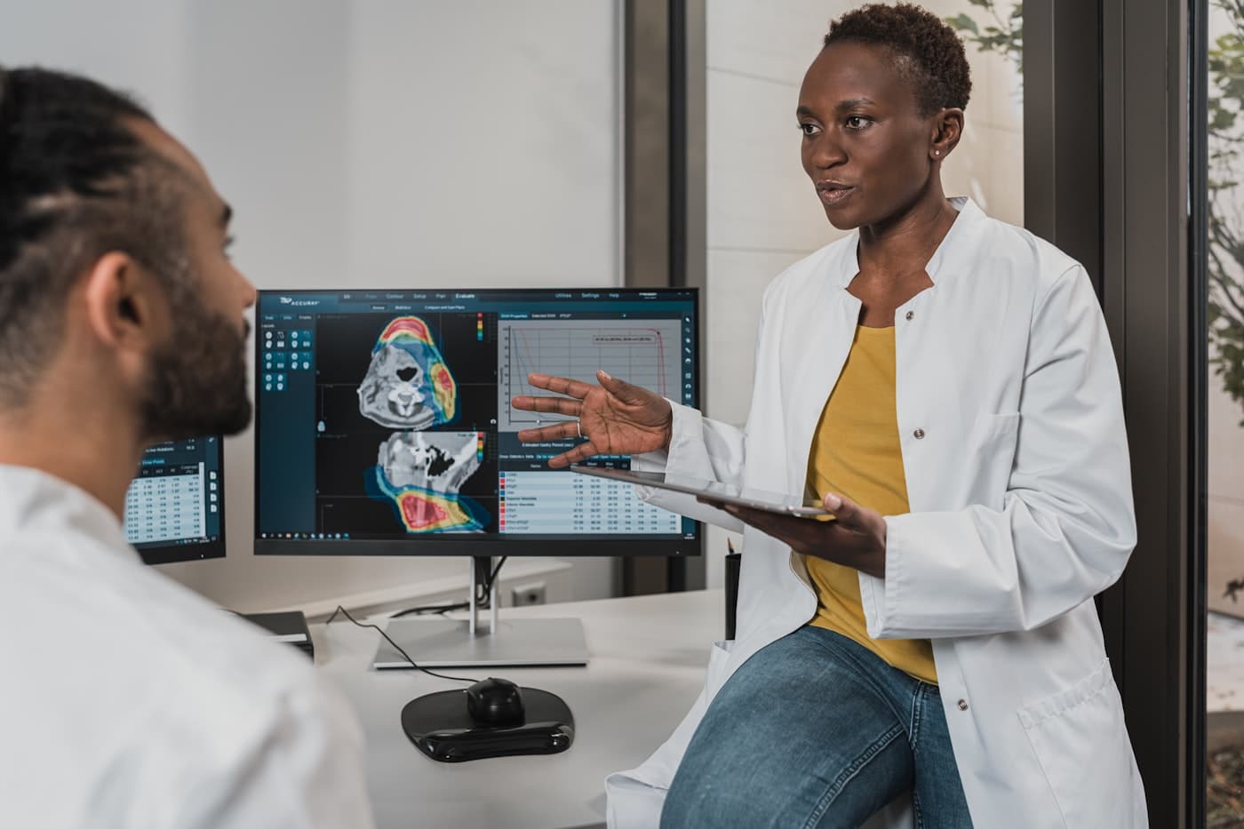 Clinician reviewing patient data and clinical outcomes on screen