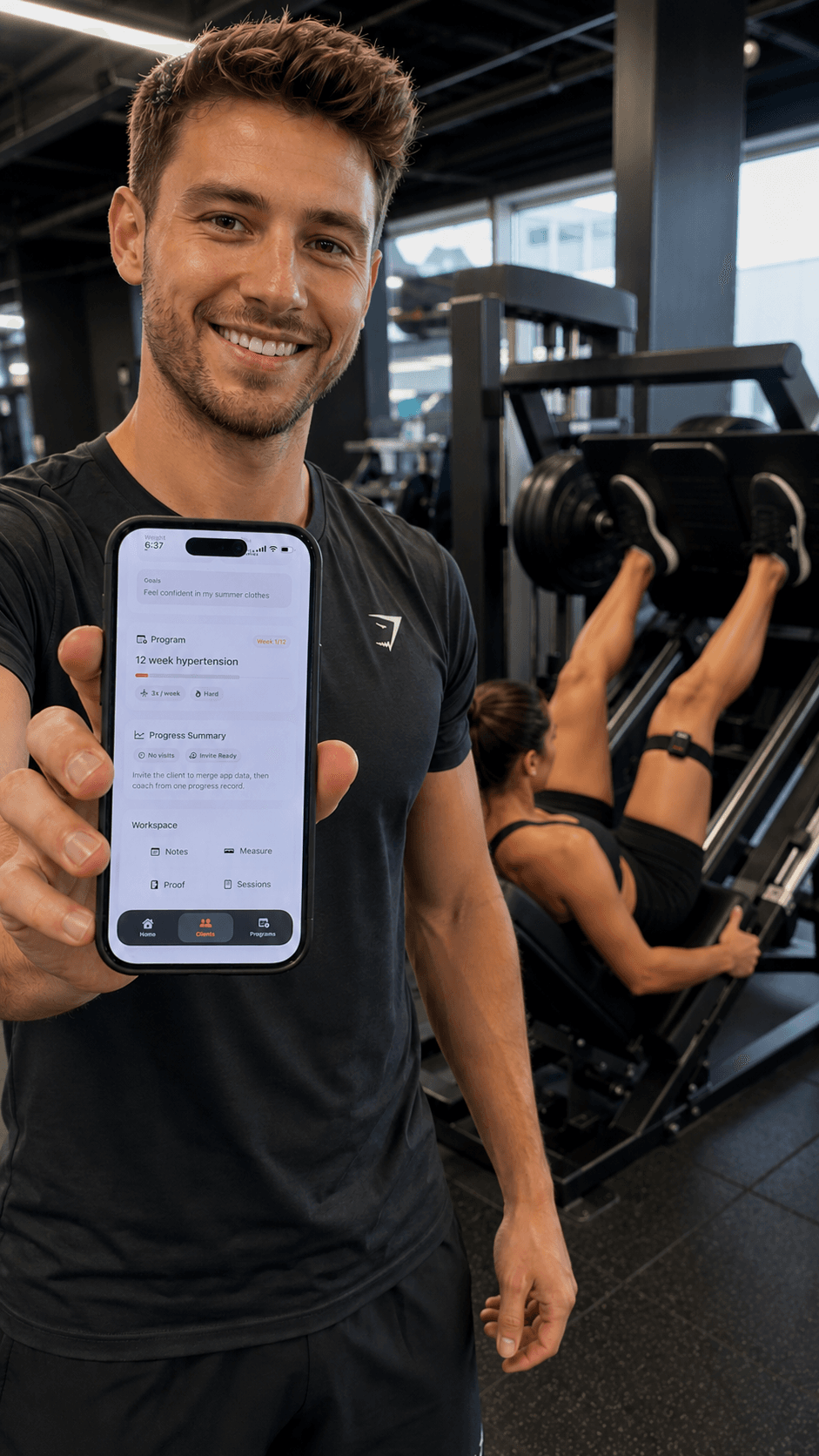Trainer holding the Inara app during a client leg press session